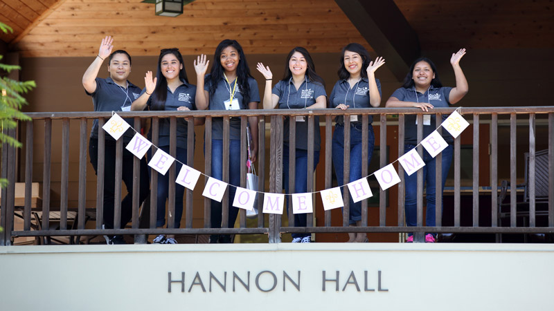 Outdoor photo of group of girls waving